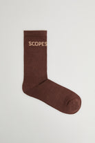 Brown cotton socks featuring the Scopes logo
Pair of brown socks with embroidered Scopes logo